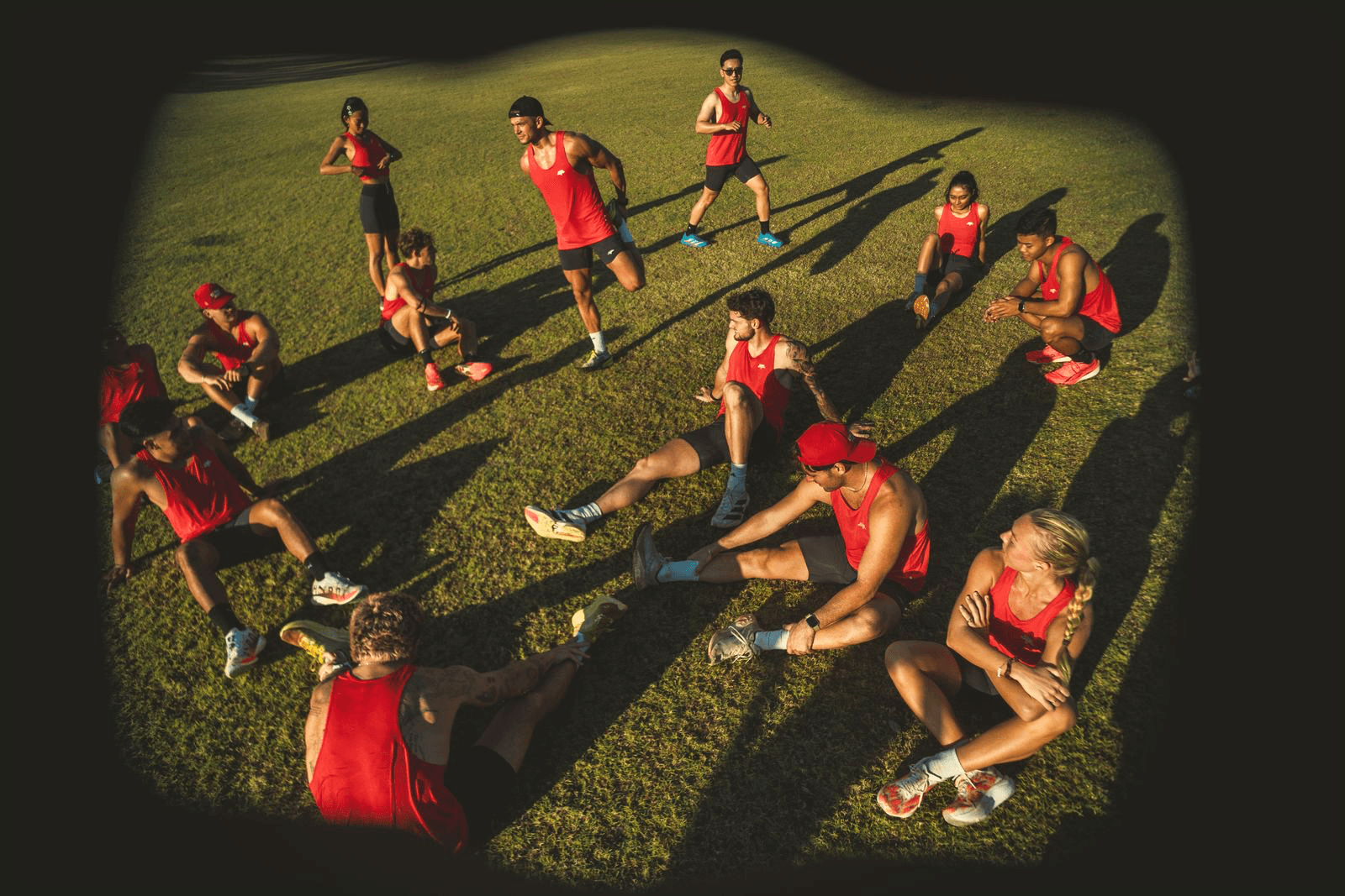 Chase Track Club runners stretching at sunset.
